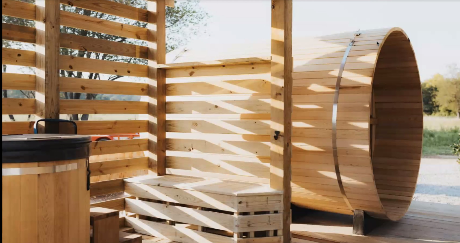 A timber barrel sauna and cold plunge area